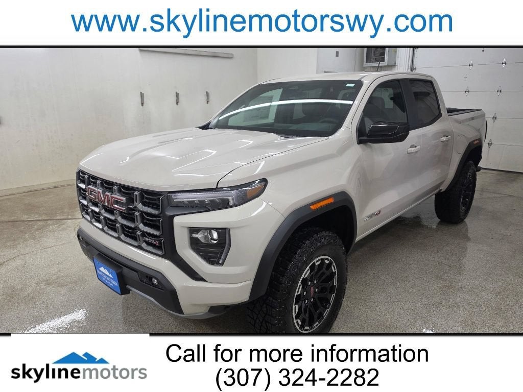 2026 GMC Canyon AT4 in Coastal Dune — front three-quarter view